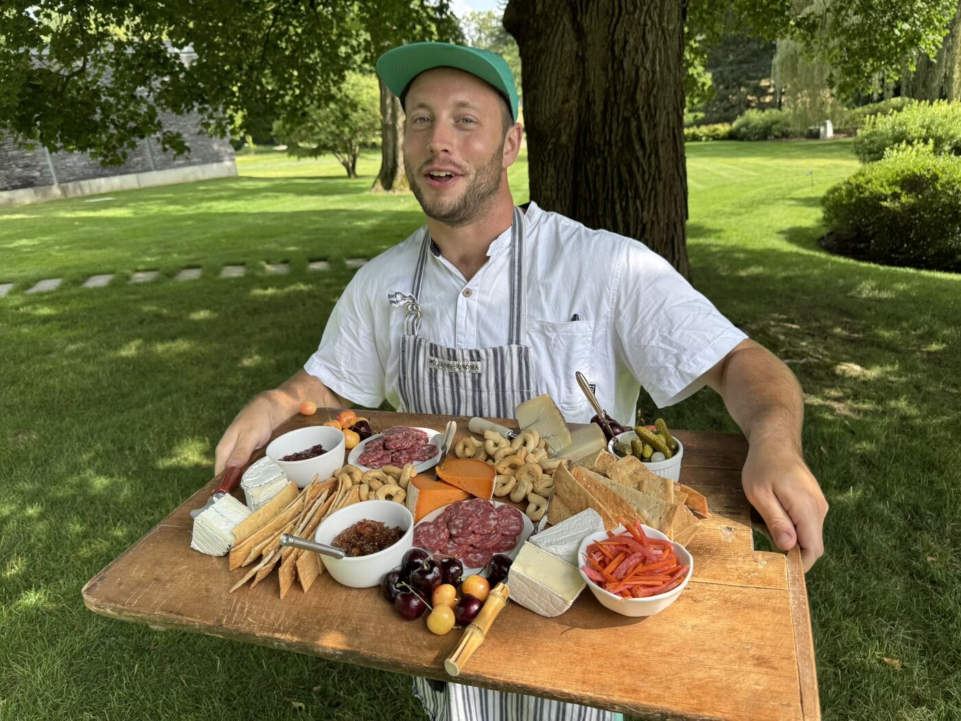Cheflon outdoors with a full charcuterie and pizza spread